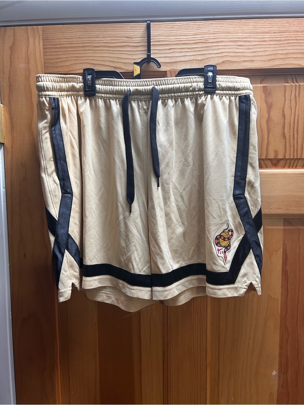 Nike Beige Athletic Shorts with Black Trim and Logo